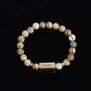 Natural stone beaded bracelet with engraved Faith metal plaque on black reflective base