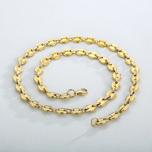 Macro view of golden coffee bean link chain with polished finish and lobster clasp