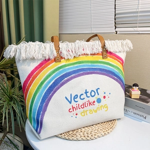 Close-up of rainbow woven tote bag with white fringe and brown leather handles