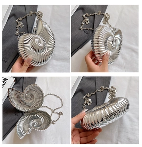 Macro views showing the silver shell-shaped nautilus evening clutch with chain strap details