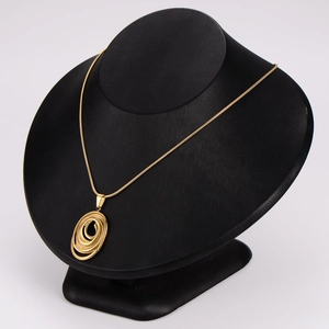 Exaggerated golden concentric circle necklace with snake chain on mannequin display