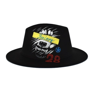 Detailed view of hand-painted animal graphics on a black wool fedora jazz hat