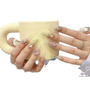 Handmade press-on nails in pale green and cream with crystal rhinestones and floral art