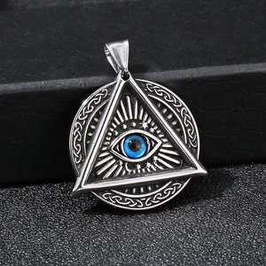 Macro detail of stainless steel All-Seeing Eye pendant with blue stone inlay