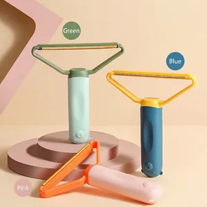 Portable pet hair remover tool for carpets and sofas in green blue and pink colors