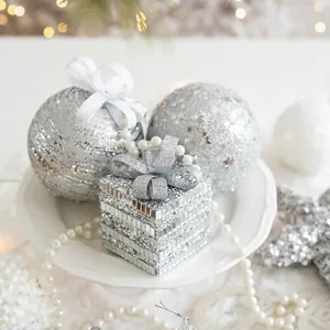 Silver foam Christmas ball set with mirror gift box and pearl string on a white plate