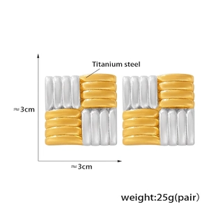 Detailed macro view of two-tone square woven pattern titanium steel earrings