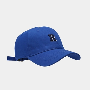 Detail of adjustable metal buckle and navy cotton strap on the R logo baseball cap
