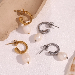 Detailed view of 18K gold and silver open hoop earrings with natural freshwater pearls