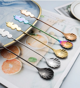 Macro detail of seahorse handle and shell-shaped head on five colorful stainless steel spoons
