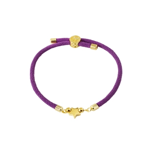 Close-up of purple woven cord bracelet with gold star charm and textured slider bead
