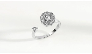 Detail of S925 sterling silver spinning flower ring with zircon stones on white background