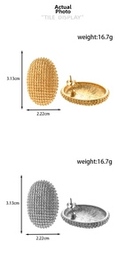 Detail view of geometric oval earrings with bead texture showing size 3.13x2.22cm and weight