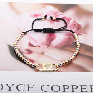 Detail of adjustable star charm bracelet with tricolor metal beads on a floral background