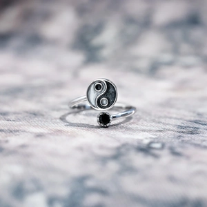 Macro shot of S925 sterling silver Yin Yang ring with black enamel and gemstone