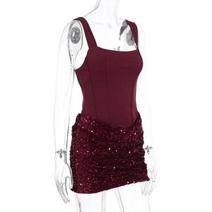 Side view of burgundy slim-fit strap vest and pleated sequin mini skirt set
