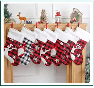 Close-up of Christmas stockings with plaid patterns and plush cuffs on a fireplace