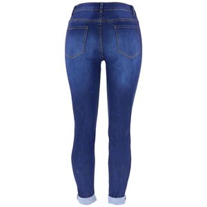 Detail of dark blue skinny jeans back view with double pockets and washed denim fabric