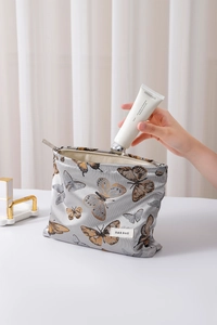Detail of vintage butterfly cosmetic bag showing storage capacity and canvas texture