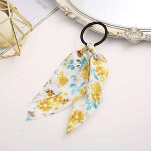 Detailed view of floral chiffon ribbon hair scrunchie with elegant yellow and blue flowers