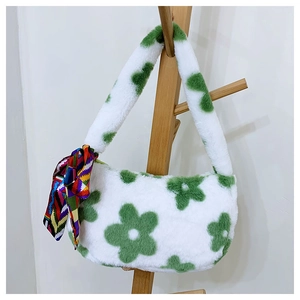 Detail of plush shoulder bag with green flower pattern and decorative silk scarf