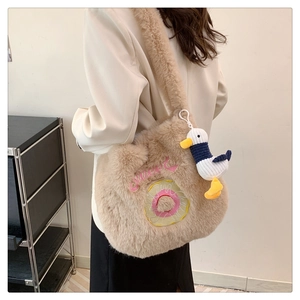 Detail of plush khaki shoulder bag with Sweet donut embroidery and cute duck charm