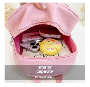 Internal capacity of pink sequin kids backpack showing storage for phone and accessories
