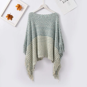 Blue and white knit chenille poncho featuring horizontal textures and fringe tassels