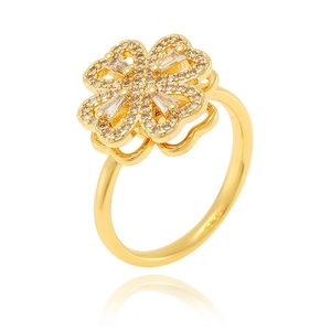 Detail of a rotating gold clover ring featuring sparkling clear square cubic zirconia stones