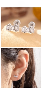 Detailed macro view of a silver bow earring with zircon stones and model ear display