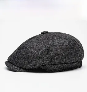 Side view of dark gray tweed newsboy cap showing wool blend texture and paneled design
