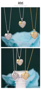 Detailed view of heart pendant necklaces with shimmering zircons and dual-tone plating