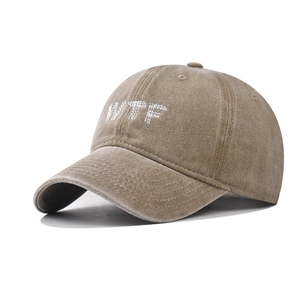 Detail of embroidered WTF letters on vintage washed cotton khaki baseball cap