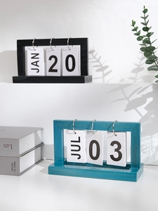 Detail of minimalist wooden flip calendars in black and cyan with stylish shadow effects