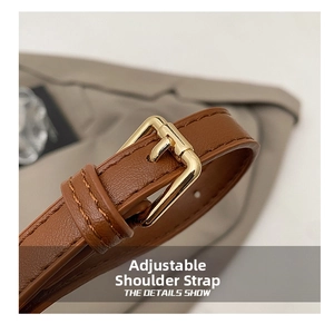 Close-up of adjustable brown leather strap with golden metal buckle and fine stitching