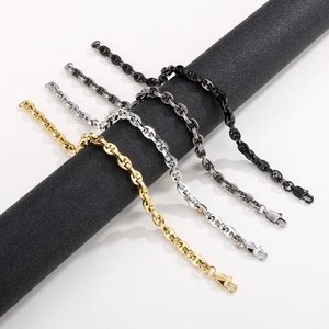 Detail of pig nose anchor chain necklace in gold, silver, dark grey and black finishes