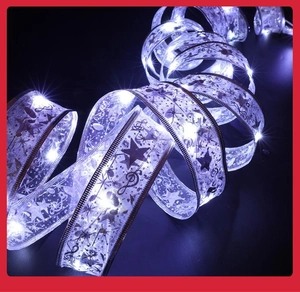 Detail of purple transparent LED ribbon with glowing star and music note patterns