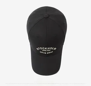 Close-up of black cotton baseball cap with white Stockholm embroidered lettering