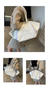 Close-up of white bowling bag with blue embroidery text and mesh panel texture