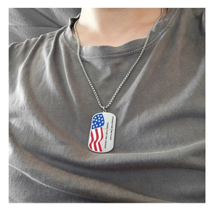 Detail of stainless steel bead chain necklace with USA flag rectangle pendant on model