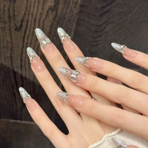 Pink sheer almond press-on nails with silver glitter gradient and rhinestone accents