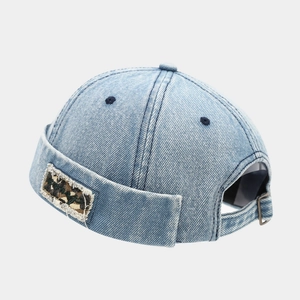 Detail of light blue denim miki hat showing camo patch and washed cotton texture
