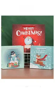 Three Christmas paper gift bags featuring Santa, snowman, and reindeer with braided handles