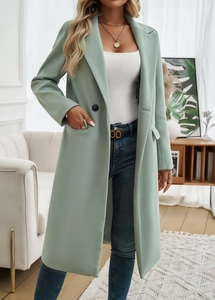 Detailed view of light green wool coat featuring a double-breasted design and lapel collar