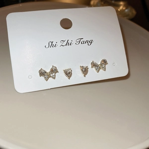 Set of four butterfly and heart stud earrings with sparkling crystals on a display card