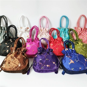Detailed view of traditional Chinese embroidery pouches in various silk color options