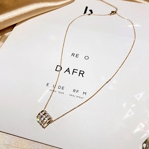 Elegant gold titanium steel necklace with sparkling crystal cylinder pendant on silk