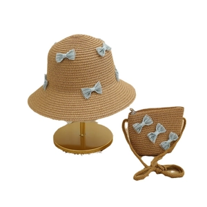 Straw sun hat and matching crossbody bag set with light blue lace bows for summer