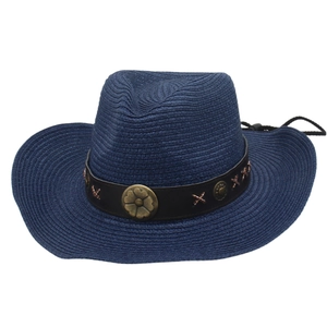 Detail of navy straw cowboy hat with vintage brown leather belt and metallic floral studs