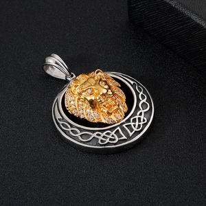 Detailed close-up of iced-out gold lion head pendant with stainless steel engraving